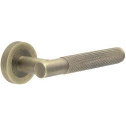 Bari Knurled Antique Brass Designer Lever on Rose